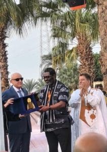 Femi Odugbemi receiving the award copy